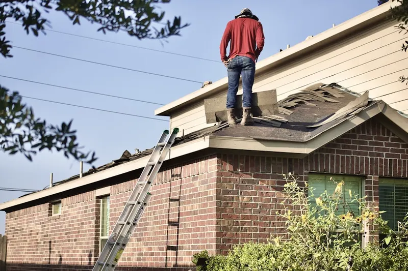 Professional roofer working on a residential roof in Lawrence Brook Manor